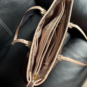 Brown shoulder bag, a laptop fits inside.